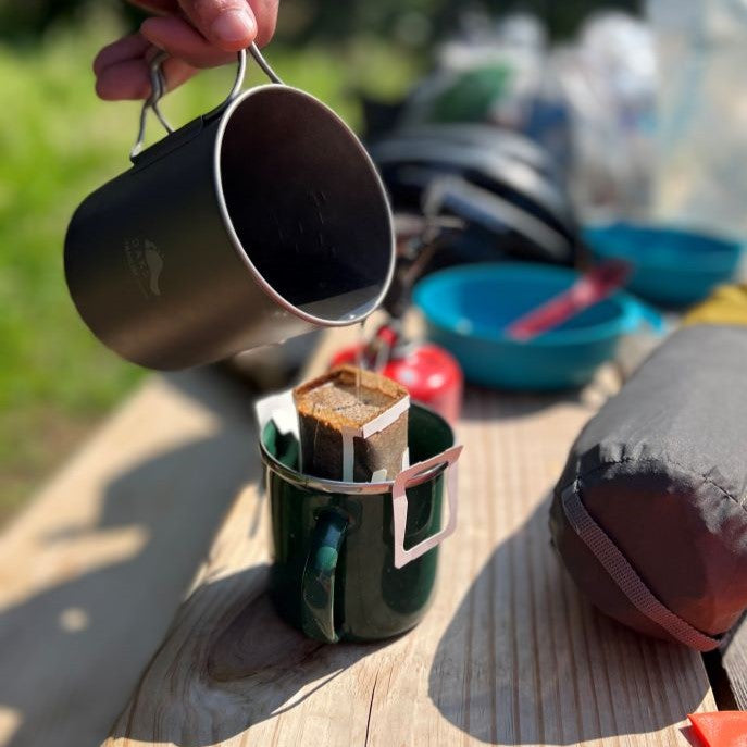 Brewing disposable pour over coffee on a camping trip
