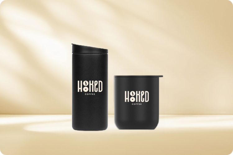 Hooked Coffee merchandise consisting of flip traveler mug and tumbler with company's logo