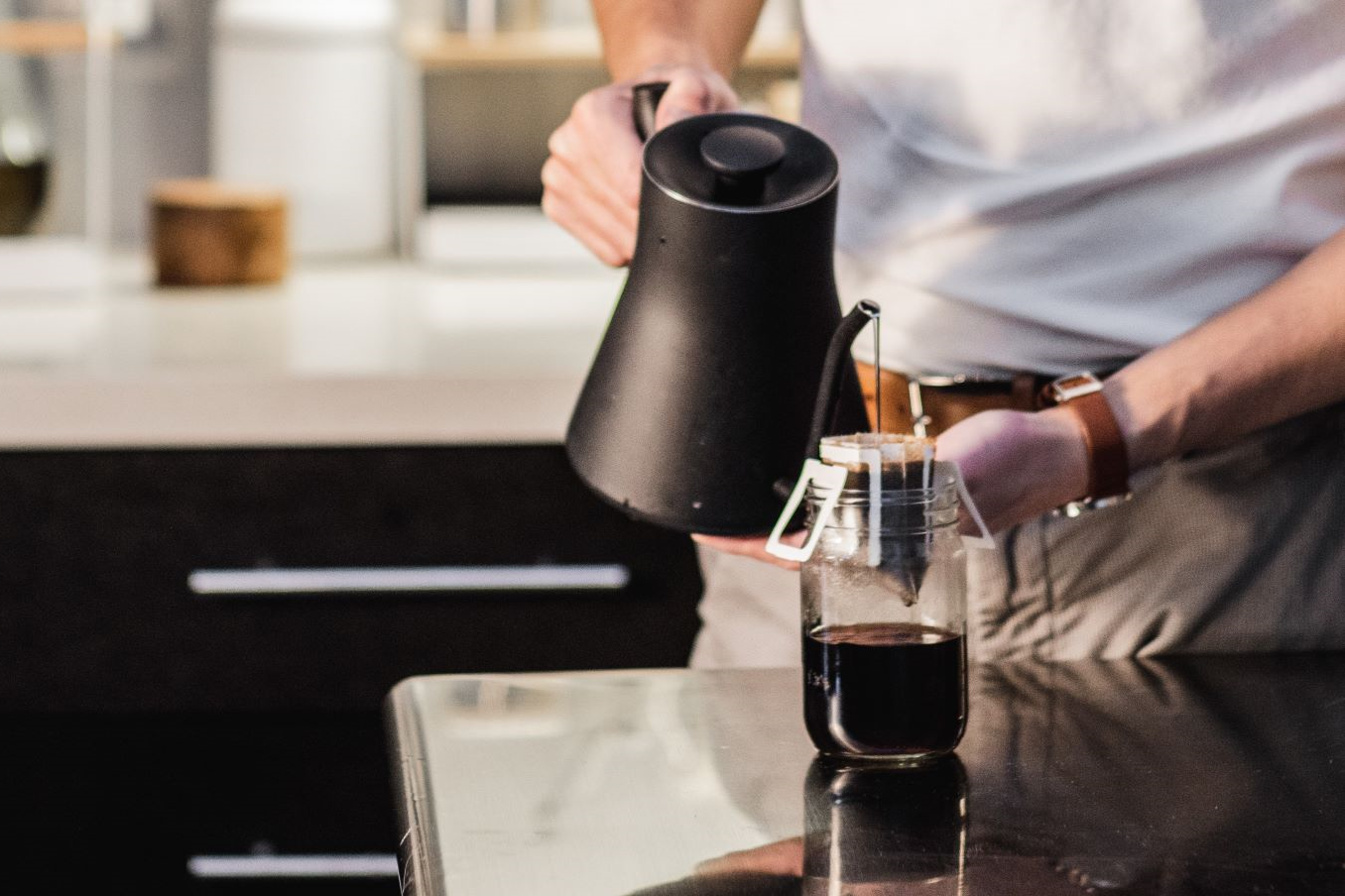 Male making coffee before work using single-serve pour over coffee pouches