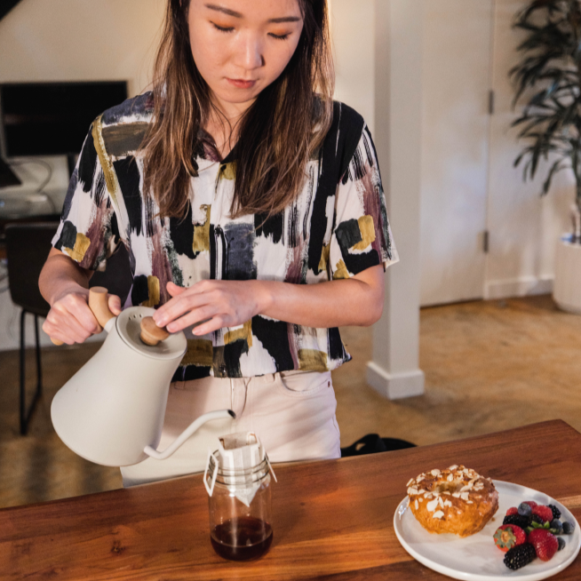 Hooked Coffee founder Natalie pouring hot water into Hooked Coffee pour over coffee pack